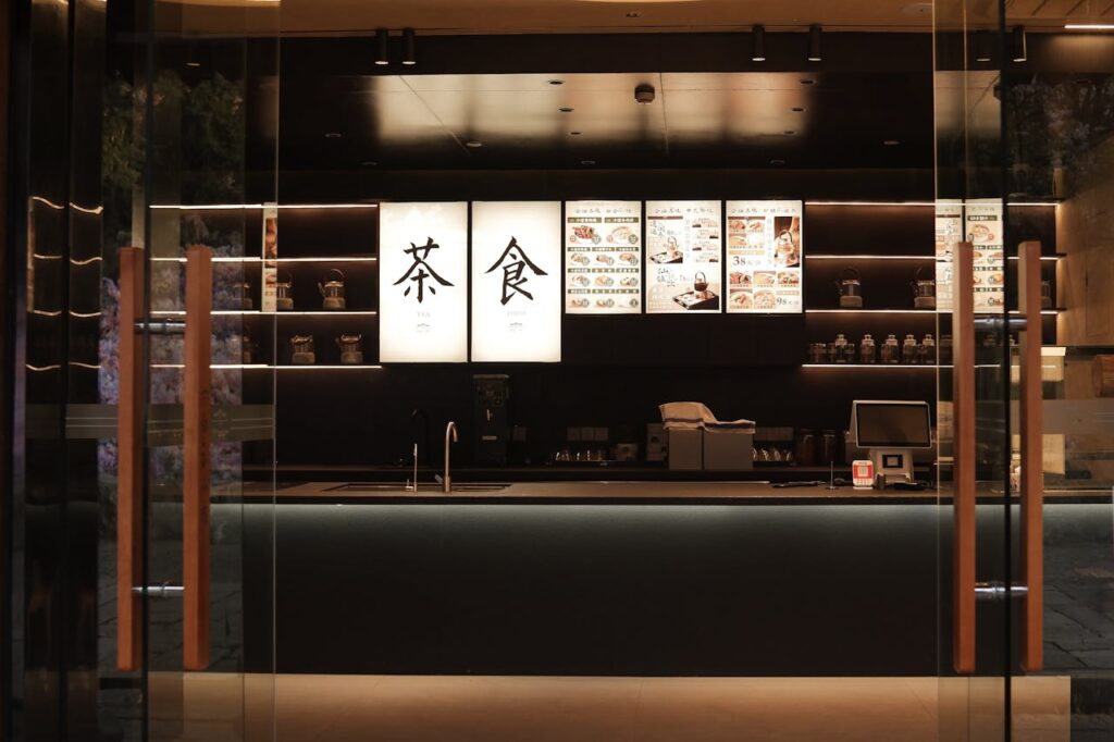 Elegant interior of a modern Asian tea shop at night, showcasing a minimalistic design.